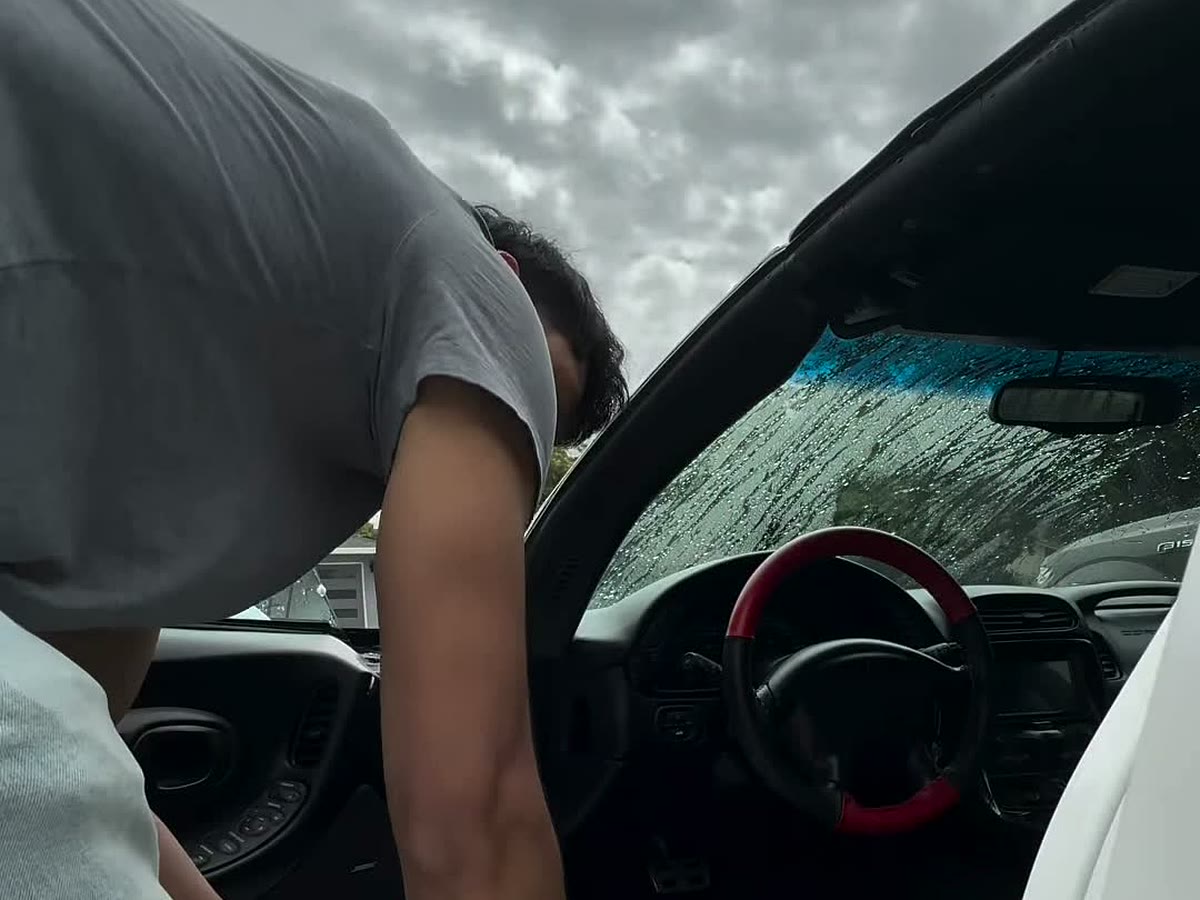 Cleaning the dash and console inside a Corvette during an interior detail